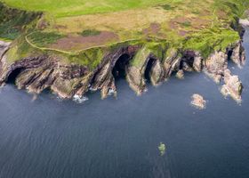 Coastal cliff path above dark water